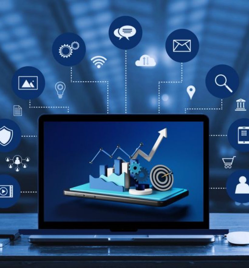 A laptop displaying a graph with rising trends sits on a desk. Surrounding the laptop are various icons about data, communication, cloud storage, search, and other digital concepts, highlighting aspects of technology and data analytics. A coffee cup and a smartphone are also on the desk.